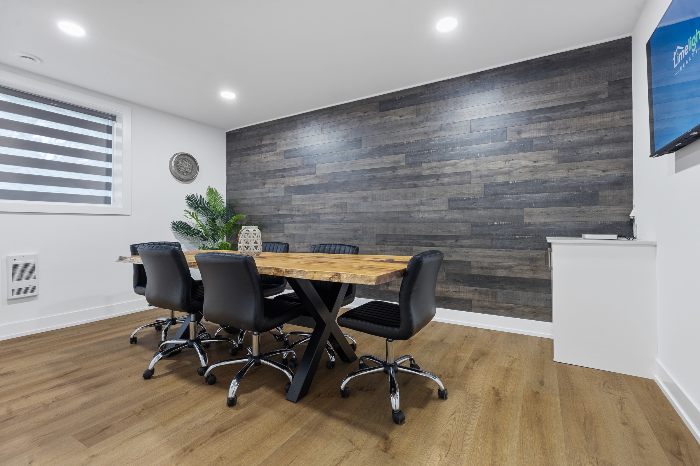 Modern Limelight Realty meeting room with live-edge conference table
